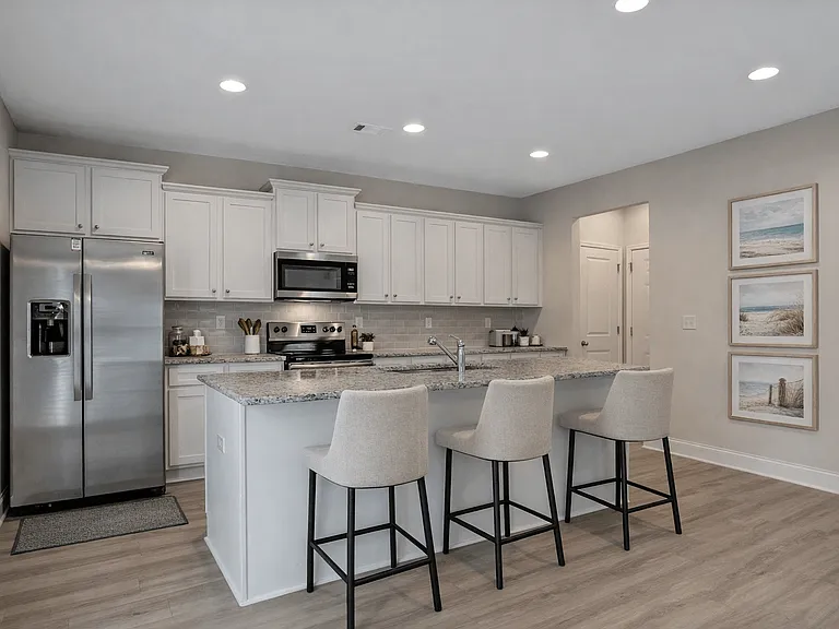 Spacious kitchen with an island, ample storage, and stainless steel appliances.
