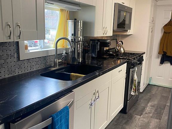 Newer white kitchen cabinets & whirlpool stainless steel appliances