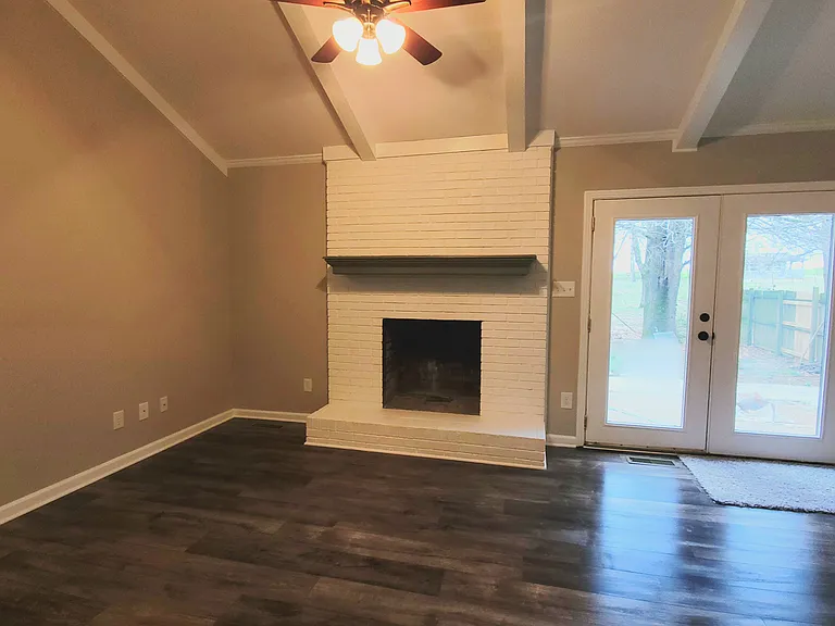 Den with ceiling fan, laminate/wood flooring, french doors to the outside patio/backyard.
