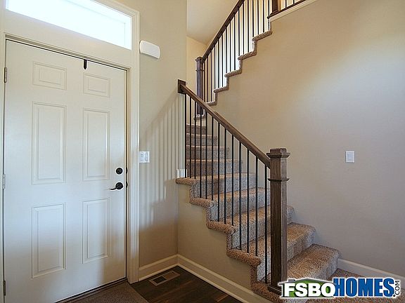 Front Entry with Open Staircase, Six Panel Doors and Light Over Entry