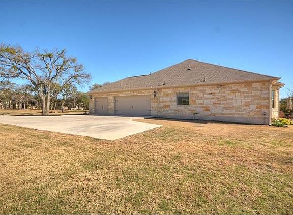 Generous guest parking is achieved with the wide apron of the Three-Car Side-Entry Garage.