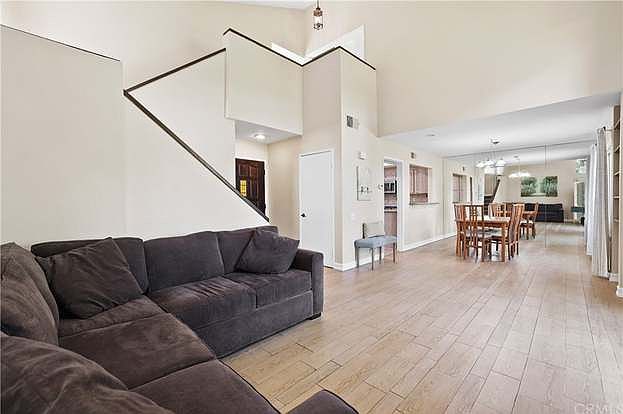 Open floor plan with kitchen and private balcony access