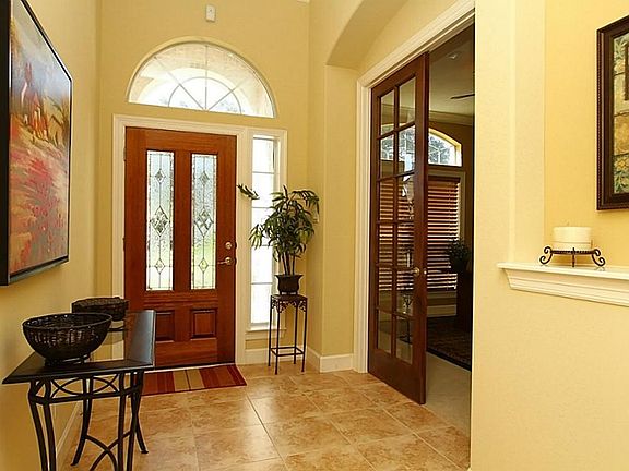 The entry of this home features a long dramatic hall with oversized tile flooring, recessed lighting, trey ceilings, art niches, rounded sheetrock, extensive crown moldings & upgraded baseboards. Every part of this home shows attention to detail!