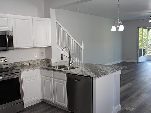 Stainless steel undermount sink, with large granite peninsula.