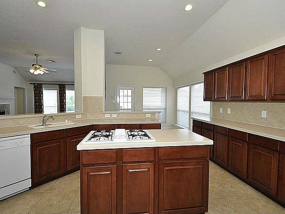 Kitchen w/corian counter-tops & island cook-top