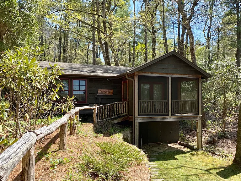 The exterior of the Knotty Pine with entrance through the screen porch.