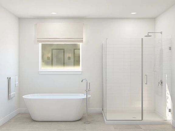 Primary bath with freestanding soaking tub glass shower enclosure