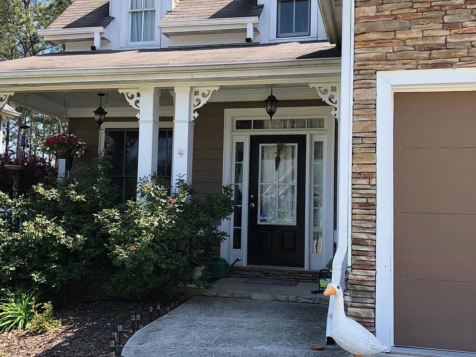 The front of the house includes a welcoming full front porch