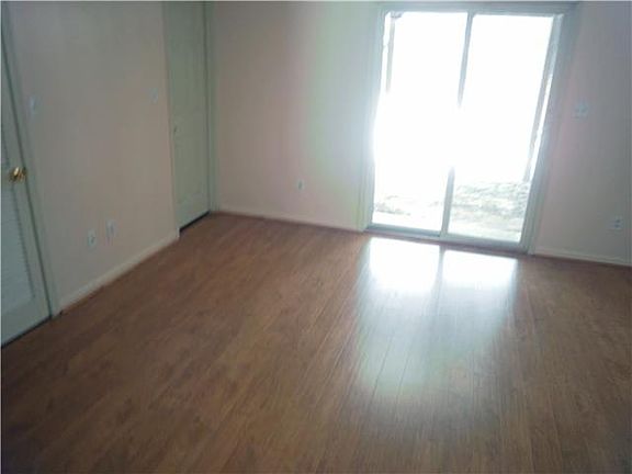 Wood laminate floor in the family room w/slider