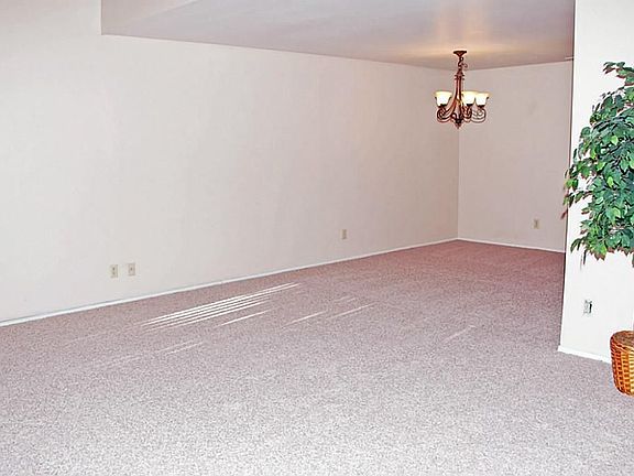 Living area leads to dining room which easily doubles a meda center.