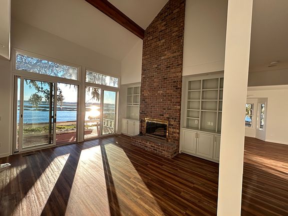 Living room with wood burning fireplace.