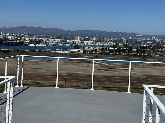 __ Expansive rooftop deck offers sweeping views from marshland to skyline_an ideal setting for elegant soirees, sunset cocktails, and starlit gatherings. With ample space and coastal breezes, it's a natural extension of indoor-outdoor living at its finest