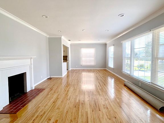 Open floor plan living room, dining area, and kitchen. Freshly painted walls with recessed & dimmable LED lights