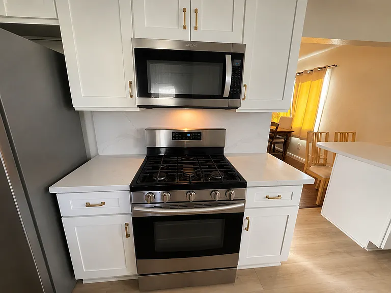 Stove and microwave. Lots of cabinets