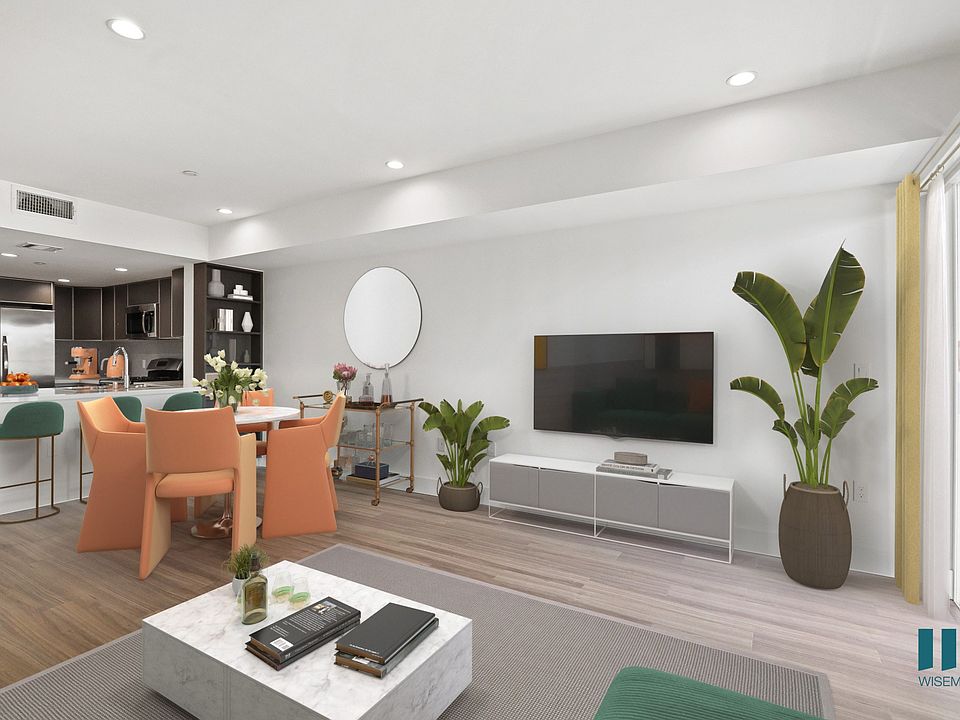 Kitchen with Countertop Bar, Dining Room, and Living Room