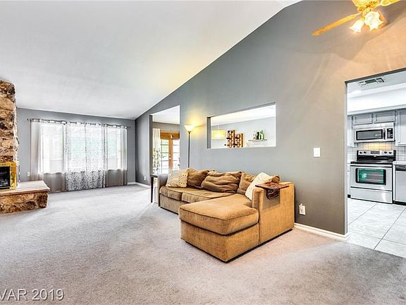 Large living room has vaulted ceilings and a stone fireplace...