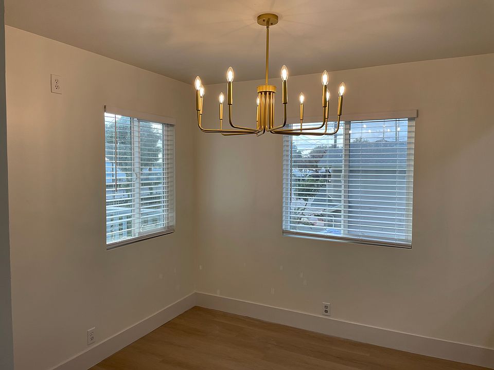A modern multi-arm gold chandelier with dimmable lights