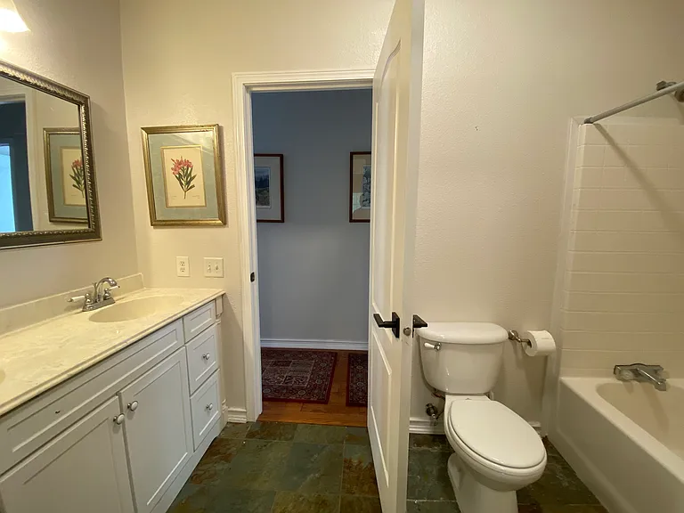 Guest Bathroom with Dual Sinks and Tub/Shower