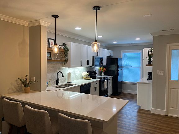 From the front door, you walk into an open floor plan downstairs with a fully stocked, freshly renovated kitchen