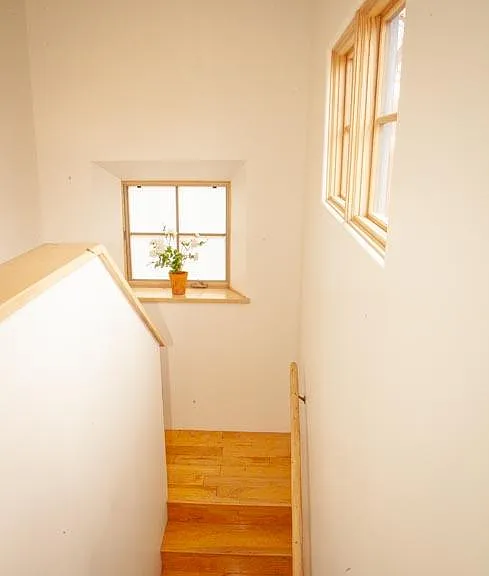 Dramatic, beautifully lit stairs lead up to the private master suite.