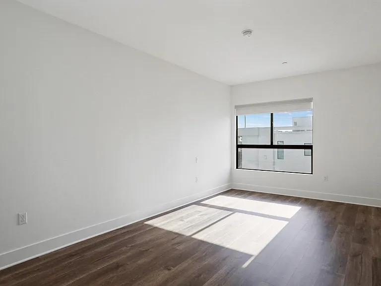 Bedroom with Vinyl Flooring and Large Windows