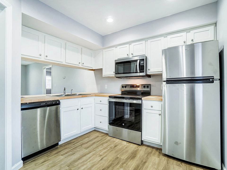 Kitchen with butcher block counter and stainless appliances