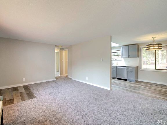 Living room. Front door to the left; kitchen with eating nook to the right. Straight ahead is 2 bedrooms and a 3/4 shower.