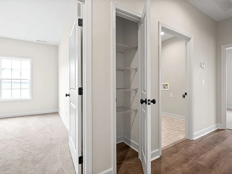 Entrance to bedroom room 1 and 2 with hallway closet and entrance to laundry room