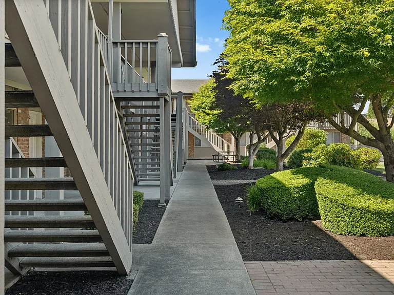 Shaded walkways and lush landscaping throughout the community.