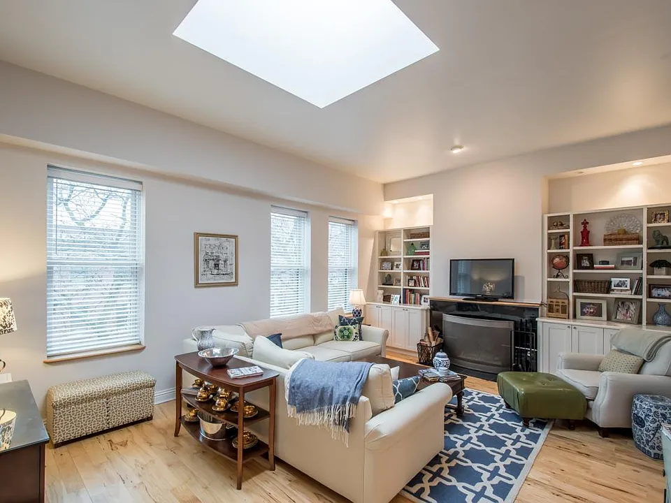 Front living room w/woodburning fireplace, built-in bookcase
