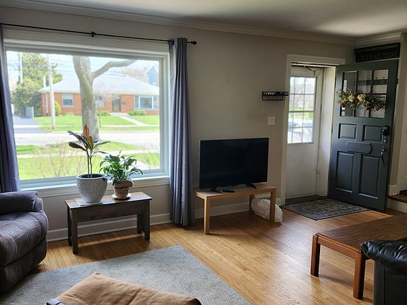Living room with front door & street window.