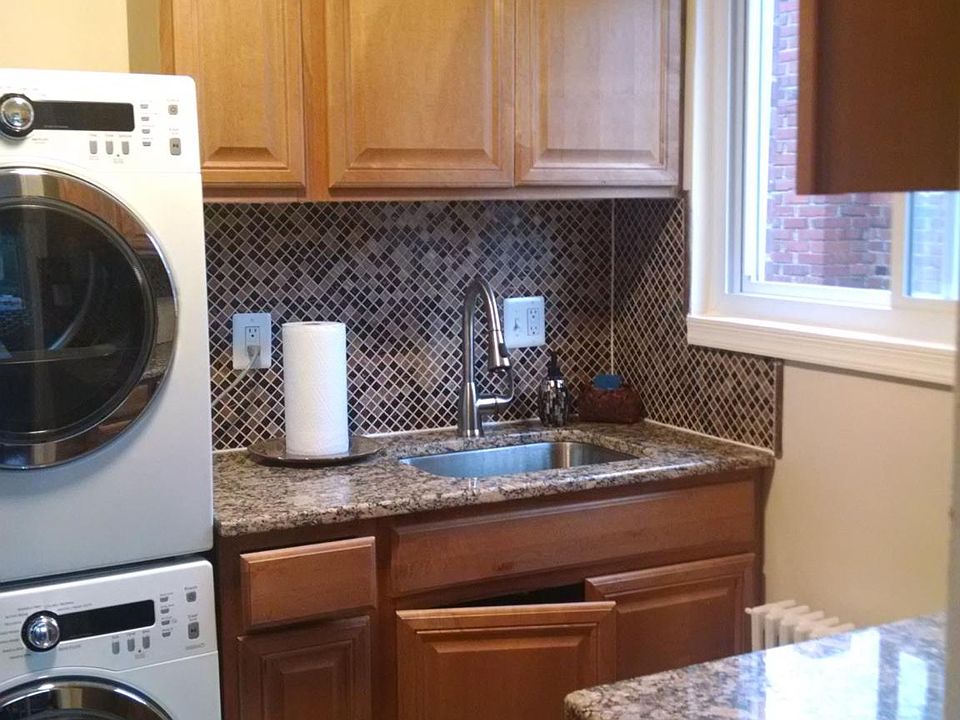 Kitchen with stainless steel, washer dryer and granite count