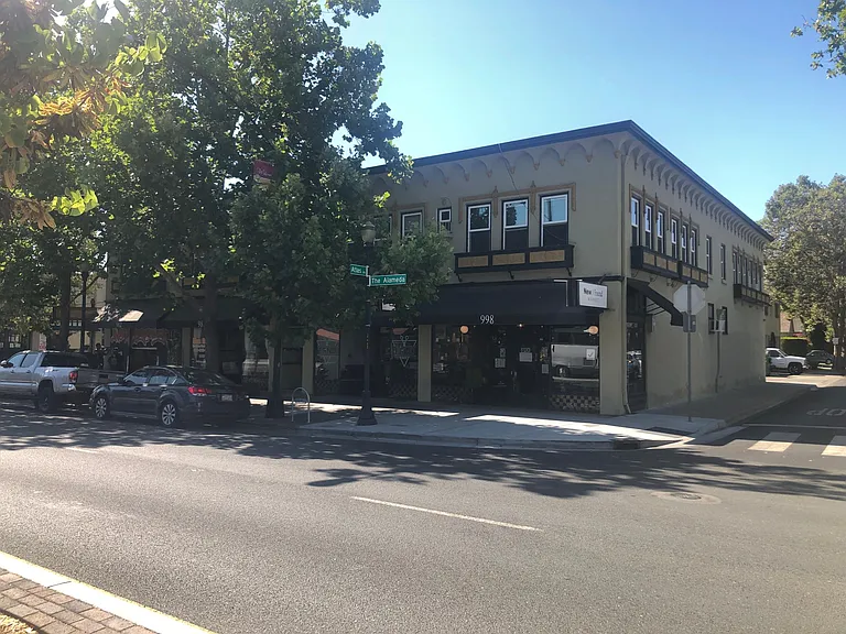 Photo of front of apartment building. Seven apartments upstairs for commercials downstairs