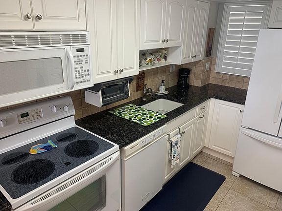 Kitchen includes microwave, refrigerator, dishwasher, stove and oven.