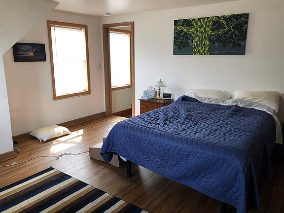Bedroom #1 (upper level; includes 1/2 bath, queen bed, desk + chair)