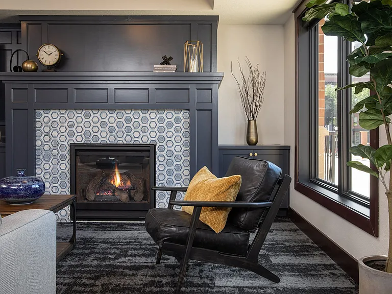 View of cozy clubhouse with fire place and seating area at The Whitley in St. Paul, MN.