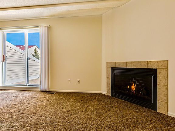 Living room with gas fireplace and spacious patio