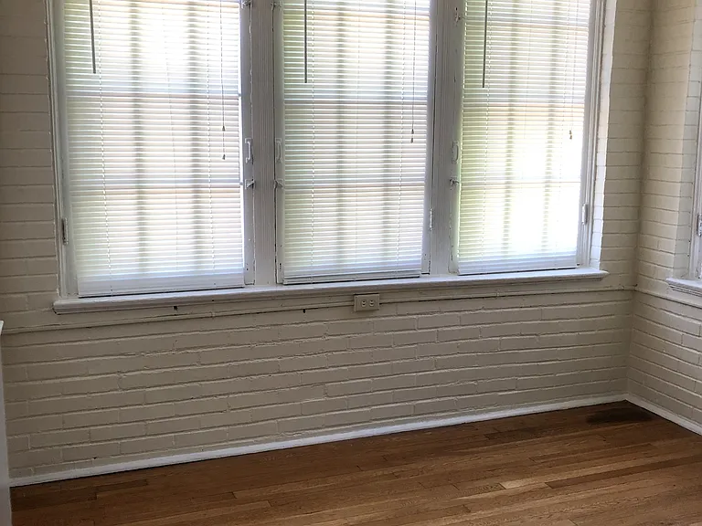 Sunroom. All windows have blinds.