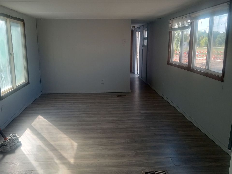 Lage living room with large windows on both sides of home to bring in a lot a natural sunlight.