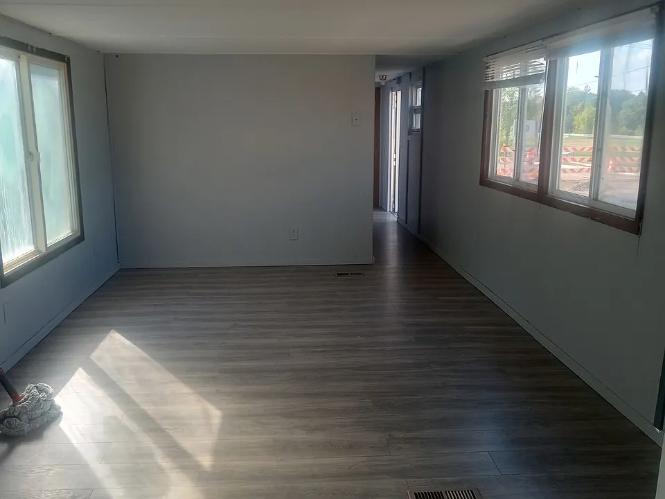 Lage living room with large windows on both sides of home to bring in a lot a natural sunlight.