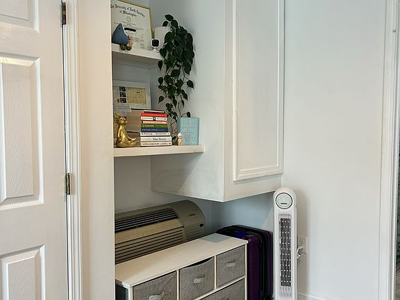 Convenient storage nook with shelving, drawer space, and room for luggage. A practical bonus area to keep your stay organized and comfortable.