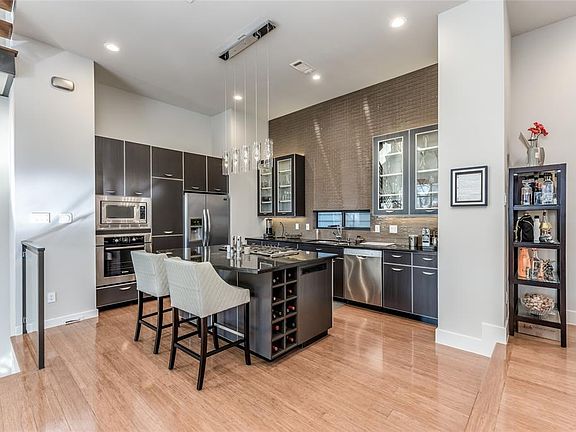 This kitchen truly has it all. Gas range, stainless steel appliances, counter to ceiling backsplash, under cabinet lighting, All kitchen cabinets and pantry have custom built pullouts for efficient storage and high end soft close hinges and drawer sl