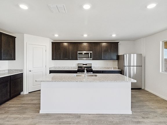 Chef-ready kitchen with a large island and stainless steel appliances.