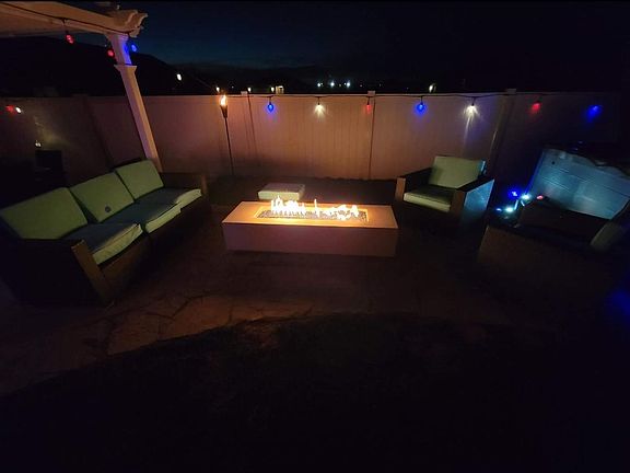 Get out of the hot tub and enjoy sitting beside enjoy the glass fire pit. No changing bottles (underground gas line), with a wifi start, outlined by a flagstone pad, rose garden and outdoor wifi lights for ambiance!