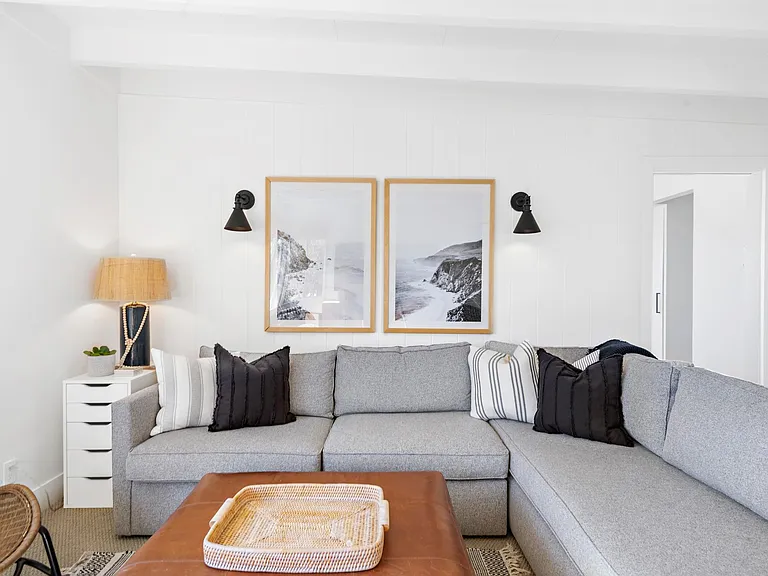 West Elm queen sized sleeper sectional, leather ottoman, very comfortable living space