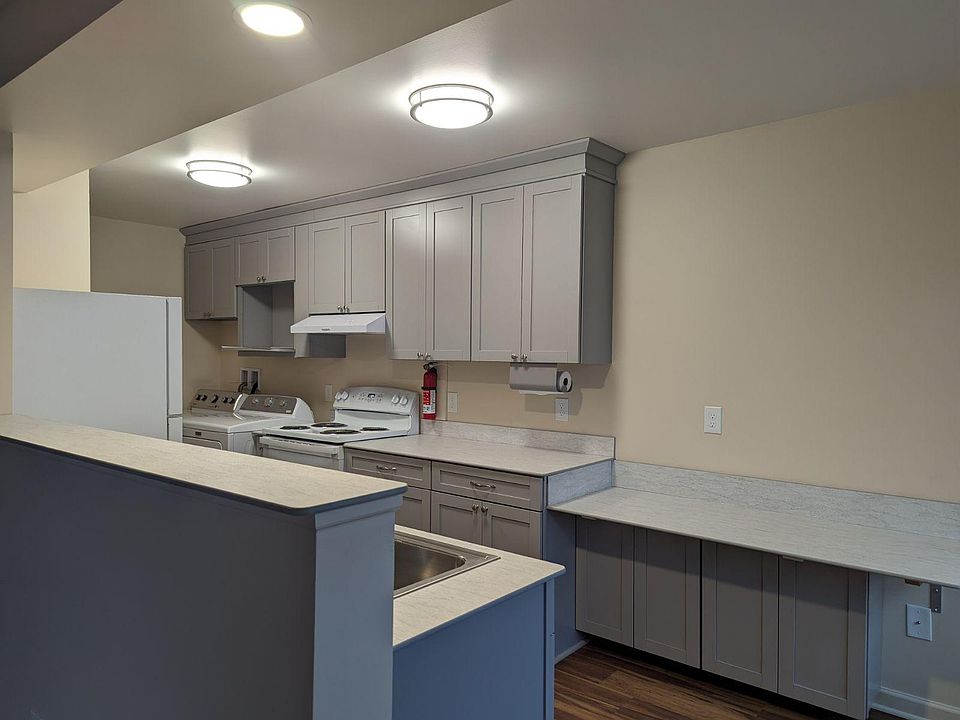 Kitchen showing eating counter which would seat up to 3 people in regular-height chairs. Lots of light in kitchen.