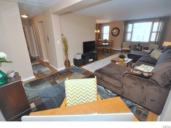The large living room opens to a "L" shaped dining room and has hardwood floors.