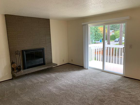 Large living room with fireplace new sliding glass door to recoated deck!
