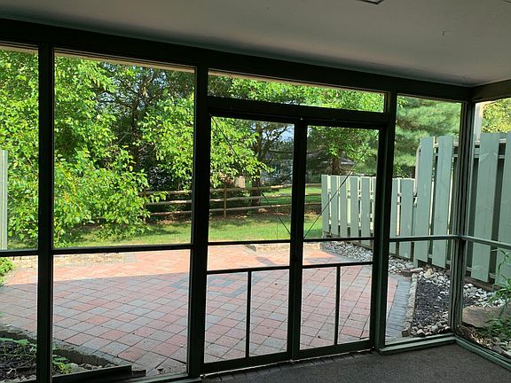 Screened in porch with pavered patio