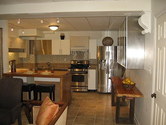 Kitchen Island-Wood Waterfall with storage cabinets underneath.